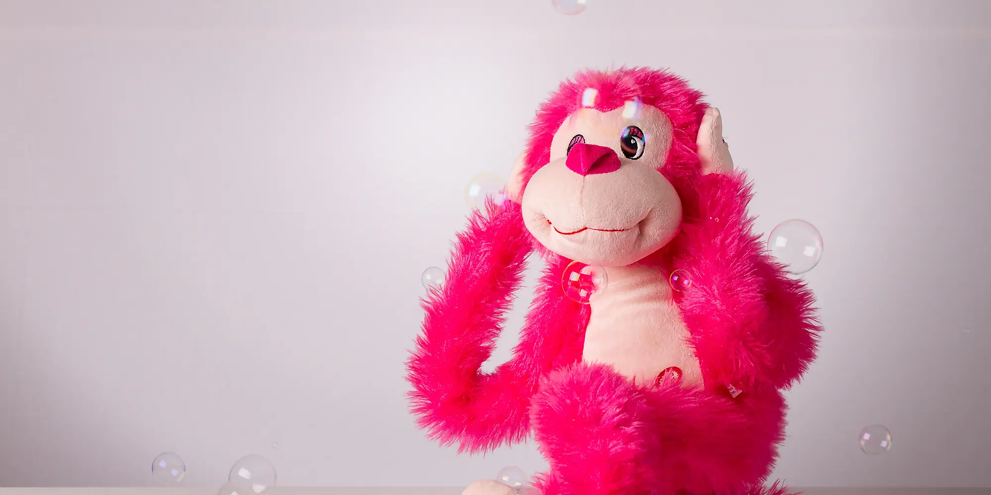 Toy monkey covering ears