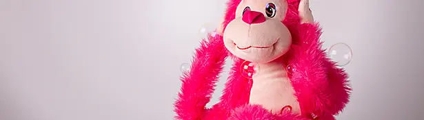 Toy monkey covering ears